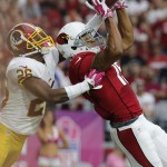 Arizona Cardinals wide receiver Michael Floyd (15) pulls in a touchdown pass as Washington Redskins strong safety Bashaud Breeland defends during the first half of an NFL football game, Sunday, Oct. 12, 2014, in Glendale, Ariz.(AP Photo/Rick Scuteri)