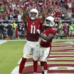 Arizona Cardinals wide receiver Larry Fitzgerald (11) celebrates his touchdown with teammate John Brown during the first half of an NFL football game against the Washington Redskins, Sunday, Oct. 12, 2014, in Glendale, Ariz. (AP Photo/Ross D. Franklin