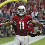 Arizona Cardinals wide receiver Larry Fitzgerald (11) celebrates his touchdown against the Washington Redskins during the first half of an NFL football game, Sunday, Oct. 12, 2014, in Glendale, Ariz. (AP Photo/Ross D. Franklin)