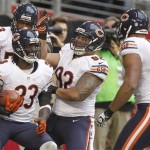 Chicago Bears cornerback Charles Tillman (33) celebrates his touchdown with teammates Stephen Paea (92), Nick Roach (53) and Corey Wootton (98) during the second half of an NFL football game against the Arizona Cardinals, Sunday, Dec. 23, 2012, in Glendale, Ariz. (AP Photo/Paul Connors)