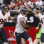 Chicago Bears defensive back Zack Bowman celebrates his touchdown with teammates Corey Wootton (98) and Chris Conte (47) during the first half of an NFL football game, Sunday, Dec. 23, 2012, in Glendale, Ariz. (AP Photo/Rick Scuteri)