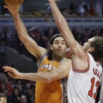 Phoenix Suns forward Luis Scola, left, passes the ball against Chicago Bulls center Joakim Noah during the first half of an NBA basketball game in Chicago on Saturday, Jan. 12, 2013. (AP Photo/Nam Y. Huh)