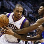 Phoenix Suns' Shannon Brown, left, tries to control the ball as Philadelphia 76ers' Nick Young reaches in to attempt a steal during the second half of an NBA basketball game on Wednesday, Jan. 2, 2013, in Phoenix. The Suns defeated the 76ers 95-89. (AP Photo/Ross D. Franklin)