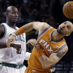 Phoenix Suns center Marcin Gortat, right, watches the ball after the tipoff against Boston Celtics power forward Kevin Garnett, left, during the first quarter of an NBA basketball game in Boston, Wednesday, Jan. 9, 2013. (AP Photo/Elise Amendola)
