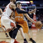 Phoenix Suns guard Goran Dragic, right, drives as Chicago Bulls forward Taj Gibson defends during the first half of an NBA basketball game in Chicago on Saturday, Jan. 12, 2013. (AP Photo/Nam Y. Huh)
