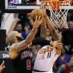  Chicago Bulls' Carlos Boozer (5) shoots over Phoenix Suns' Markieff Morris during the second half of an NBA basketball game, Tuesday, Feb. 4, 2014, in Phoenix. (AP Photo/Matt York)