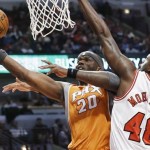 Phoenix Suns center Jermaine O'Neal, left, drives to the basket against Chicago Bulls center Nazr Mohammed during the first half of an NBA basketball game in Chicago on Saturday, Jan. 12, 2013. (AP Photo/Nam Y. Huh)