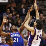 Phoenix Suns' Luis Scola (14), of Argentina, shoots over Philadelphia 76ers' Thaddeus Young (21) during the first half of an NBA basketball game, Wednesday, Jan. 2, 2013, in Phoenix. (AP Photo/Ross D. Franklin)