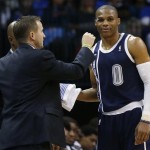 Oklahoma City Thunder head coach Scott Brooks, left, reaches to check the bandage on guard Russell Westbrook (0) during the fourth quarter of an NBA basketball game against the Phoenix Suns in Oklahoma City, Monday, Dec. 31, 2012. Oklahoma City won 114-96. (AP Photo/Sue Ogrocki)