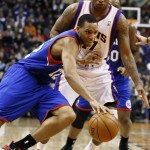 Philadelphia 76ers' Evan Turner (12) tries to keep the ball away from Phoenix Suns' P.J. Tucker during the first half of an NBA basketball game on Wednesday, Jan. 2, 2013, in Phoenix. (AP Photo/Ross D. Franklin)