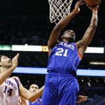 Philadelphia 76ers' Thaddeus Young (21) shoots past Phoenix Suns' Luis Scola (14), of Argentina, during the first half of an NBA basketball game, Wednesday, Jan. 2, 2013, in Phoenix. (AP Photo/Ross D. Franklin)