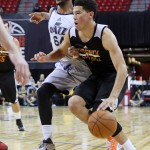 Phoenix Suns' Devin Booker, right, is fouled by Utah Jazz's Levi Randolph during the second half of an NBA summer league basketball game Tuesday, July 14, 2015, in Las Vegas. Phoenix Suns won 91-82. (AP Photo/Ronda Churchill)
