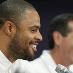 A smiling Phoenix Suns' Tyson Chandler, left, the newly signed free agent, laughs along with head coach Jeff Hornacek, right, as Chandler is introduced to the media during a news conference Thursday, July 9, 2015, in Phoenix. (AP Photo/Ross D. Franklin)