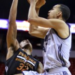 Utah Jazz's Trey Lyles, right, goes up for a shot as Phoenix Suns' Justin Harper defends during the first half of an NBA summer league basketball game Tuesday, July 14, 2015, in Las Vegas. The Suns won 91-82. (AP Photo/Ronda Churchill)
