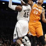 Brooklyn Nets' Gerald Wallace (45)is fouled by Phoenix Suns' P.J. Tucker (17) and then falls on to the court injured in the first half of an NBA basketball game on Friday, Jan., 11, 2013 at Barclays Center in New York. Wallace left the game. (AP Photo/Kathy Kmonicek)
