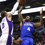 Phoenix Suns' Michael Beasley (0) blocks the shot of Philadelphia 76ers' Dorell Wright (4) during the first half of their NBA basketball game, Wednesday, Jan. 2, 2013, in Phoenix. (AP Photo/Ross D. Franklin)