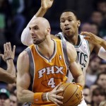 Phoenix Suns center Marcin Gortat (4) looks to make a move against the defense of Boston Celtics power forward Jared Sullinger (7) during the first quarter of an NBA basketball game in Boston, Wednesday, Jan. 9, 2013. (AP Photo/Elise Amendola)