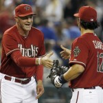Arizona Diamondbacks manager Kirk Gibson, left, smiles as he shakes hands with Eric Chavez (12) after a baseball game against the Los Angeles Dodgers on Sunday, May 18, 2014, in Phoenix. Chavez homered in the game and the Diamondbacks defeated the Dodgers 5-3 for their first series win of 2014. (AP Photo/Ross D. Franklin)