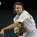 Former Arizona Diamondbacks pitcher Randy Johnson throws out the first pitch during ceremonies commemorating the 10th anniversary of Johnson's perfect game prior to a baseball game between the Diamondbacks and the Los Angeles Dodgers on Sunday, May 18, 2014, in Phoenix. (AP Photo/Ross D. Franklin)