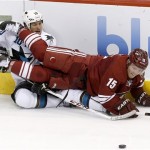 San Jose Sharks' Andrew Desjardins (10) and Phoenix Coyotes' Max Domi (15) tangle in front of the puck during the second period in an NHL preseason hockey game on Friday, Sept. 27, 2013, in Glendale, Ariz. (AP Photo/Ross D. Franklin)