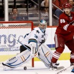 San Jose Sharks' Alex Stalock (32) makes a save on a shot as Phoenix Coyotes' Mikkel Boedker, of Denmark, looks on during the third period in an NHL preseason hockey game on Friday, Sept. 27, 2013, in Glendale, Ariz. The Coyotes defeated the Sharks 2-1. (AP Photo/Ross D. Franklin)