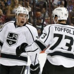 Los Angeles Kings' Tanner Pearson (70) celebrates his goal against the Arizona Coyotes with teammate Tyler Toffoli (73) during the first period of an NHL hockey game Saturday, Oct. 11, 2014, in Glendale, Ariz. (AP Photo/Ross D. Franklin)