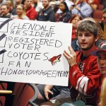 
              In this photo taken Wednesday, June 10, 2015, Arizona Coyotes fans Chris Webb, second from right, and Andrew Hill  show their support for their team as the as the Glendale Council votes to back out of an arena lease agreement with the NHL team during a special council meeting in Glendale, Ariz. (David Kadlubowski/The Arizona Republic via AP)  MARICOPA COUNTY OUT; MAGS OUT; NO SALES; MANDATORY CREDIT
            