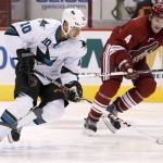 San Jose Sharks' Andrew Desjardins (10) skates with the puck in front of Phoenix Coyotes' Zbynek Michalek (4), of the Czech Republic, during the third period in an NHL preseason hockey game on Friday, Sept. 27, 2013, in Glendale, Ariz. The Coyotes defeated the Sharks 2-1. (AP Photo/Ross D. Franklin)