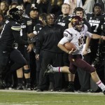 Arizona State quarterback Taylor Kelly, right, runs past Colorado linebacker Derrick Webb for a short gain in the first quarter of an NCAA college football game in Boulder, Colo., Thursday, Oct. 11, 2012. (AP Photo/David Zalubowski)