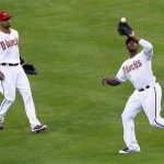 Arizona Diamondbacks' Justin Upton, right, catches a fly out by San Francisco Giants' Brandon Crawford as Diamondbacks' Chris Young watches during the second inning of an opening day baseball game, Friday, April 6, 2012, in Phoenix. (AP Photo/Matt York)
