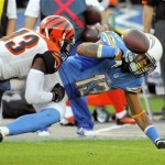 San Diego Chargers wide receiver Keenan Allen, right, fumbles the ball as he is tackled by Cincinnati Bengals strong safety George Iloka during the second half of an NFL football game Sunday, Dec. 1, 2013, in San Diego. (AP Photo/Denis Poroy)