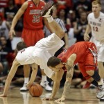  San Diego State forward Matt Shrigley, left, is taken down by a block from Arizona guard Gabe York during the first half of an NCAA college basketball game Thursday, Nov. 14, 2013, in San Diego. York got the foul. (AP Photo/Lenny Ignelzi)