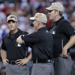 From left; Umpires Quinn Wolcott, Lance Barksdale and Chris Conroy wear camouflage hats for Memorial Day prior to an Arizona Diamondbacks and Texas Rangers nter league baseball game, Monday, May 27, 2013, in Phoenix. (AP Photo/Matt York)