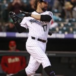Colorado Rockies' Todd Helton loses his helmet while batting in the second inning of a baseball game against the Arizona Diamondbacks at Coors Field in Denver, Friday, April 19, 2013. (AP Photo/Brennan Linsley)