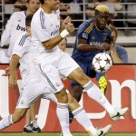 Los Angeles Galaxy's Gyasi Zardes, right, shoots on goal as Real Madrid's Pepe defends during the first half of the International Champions Cup soccer match Thursday, Aug. 1, 2013, in Glendale, Ariz. (AP Photo/Matt York)