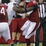 Arizona Cardinals quarterback Kevin Kolb (4) is sacked for a safety by Oakland Raiders defensive end Tommy Kelly (93) during the first half of a preseason NFL football game, Friday, Aug. 17, 2012, in Glendale, Ariz. (AP Photo/Rick Scuteri)