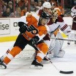 Philadelphia Flyers' Vincent Lecavalier, front, swings around the net while defended by Phoenix Coyotes' Rostisslav Klesla and goalie Thomas Greiss in the second period of an NHL hockey game on Friday, Oct. 11, 2013, in Philadelphia. The Coyotes won 2-1. (AP Photo/Tom Mihalek)