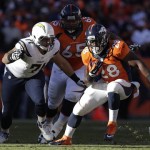 Denver Broncos running back Montee Ball (28) gets away from San Diego Chargers defensive tackle Lawrence Guy (71) in the second quarter of an NFL AFC division playoff football game, Sunday, Jan. 12, 2014, in Denver. (AP Photo/Joe Mahoney)