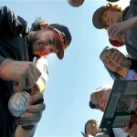 San Francisco Giants' Brandon Crawford signs autographs for fans prior to a spring training baseball game against the Chicago White Sox, Monday, Feb. 25, 2013, in Scottsdale, Ariz. (AP Photo/Matt York)
