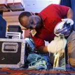 Wilfred Spencer polishes the Vince Lombardi Trophy before a news conference for NFL football's Super Bowl XLVI Friday, Feb. 3, 2012, in Indianapolis. (AP Photo/David J. Phillip)