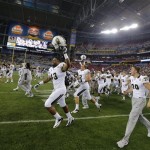 Central Florida players run onto the field after the Fiesta Bowl NCAA college football game against Baylor, Wednesday, Jan. 1, 2014, in Glendale, Ariz. Central Florida won 52-42. (AP Photo/Matt York)