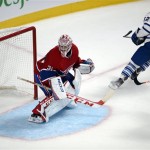 Toronto Maple Leafs center Tyler Bozak (42) scores a goal against Montreal Canadiens goalie Carey Price (31) during second period of an NHL hockey game on Tuesday, Oct. 1, 2013, in Montreal. (AP Photo/The Canadian Press, Ryan Remiorz)

