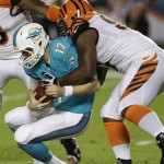 Miami Dolphins quarterback Ryan Tannehill (17) is sacked by Cincinnati Bengals defensive tackle Geno Atkins during the first half of an NFL football game, Thursday, Oct. 31, 2013, in Miami Gardens, Fla. (AP Photo/Wilfredo Lee)