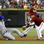 Arizona Diamondbacks second baseman Aaron Hill, right, tags out Chicago Cubs' Anthony Rizzo on a pick-off play in the third inning of a baseball game Sunday, Sept. 30, 2012, in Phoenix. (AP Photo/Rick Scuteri)
