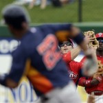 Philadelphia Phillies' Chase Utley, center, catches a fly out by Houston Astros' Carlos Corporan, left, during the second inning of an exhibition spring training baseball game, Saturday, Feb. 23, 2013, in Clearwater, in Fla. At right is Domonic Brown. Houston won 8-3. (AP Photo/Matt Slocum)
