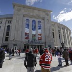  Fans arrive before an outdoor NHL hockey game between the New Jersey Devils and the New York Rangers Sunday, Jan. 26, 2014, at Yankee Stadium in New York. (AP Photo/Frank Franklin II)