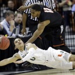 Pacific's Lorenzo McCloud (11) and Miami's Shane Larkin (0) battle for a loose ball during the first half of a second-round game of the NCAA college basketball tournament Friday, March 22, 2013, in Austin, Texas. (AP Photo/David J. Phillip)