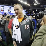 Denver Broncos' Peyton Manning makes his way to a seat for media day for the NFL Super Bowl XLVIII football game Tuesday, Jan. 28, 2014, in Newark, N.J. (AP Photo/Charlie Riedel)