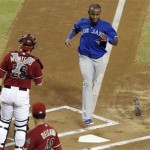 Toronto Blue Jays' Jose Reyes, top right, scores a run as Arizona Diamondbacks' Miguel Montero (26) and Randall Delgado (48) look on in the first inning of a baseball game on Wednesday, Sept. 4, 2013, in Phoenix. (AP Photo/Ross D. Franklin)