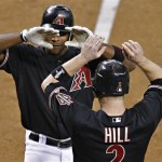 Arizona Diamondbacks' Justin Upton high fives teammate Aaron Hill (2) after hitting a two-run home run against the Chicago Cubs during the fifth inning of a baseball game, Saturday, Sept. 29, 2012,in Phoenix. (AP Photo/Matt York)